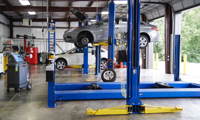 Car on lift in garage